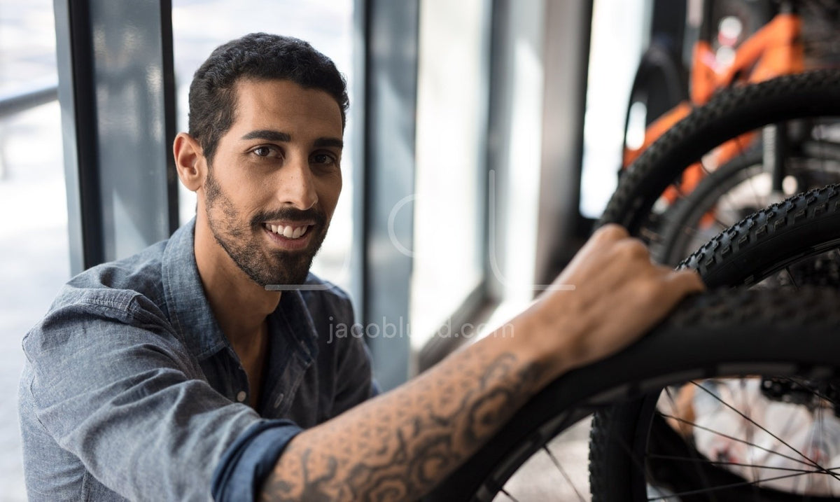 Man in a bicycle workshop – Jacob Lund Photography Store- premium stock photo